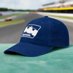 INDYCAR Unstructured Hat Featured on a race track with car in the background